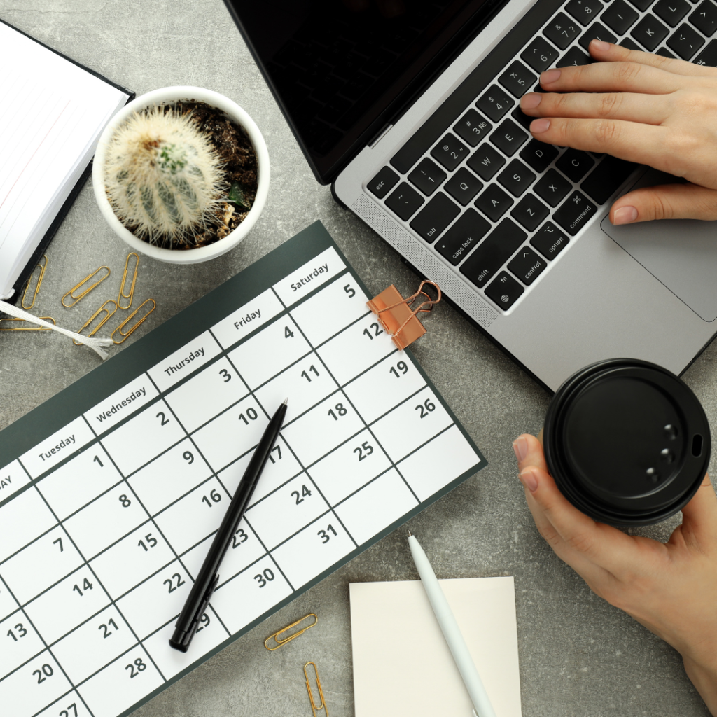 Program launch timeline — laptop and calendar (1080×1080) Top view of a desk with laptop, calendar, pen, and coffee cup